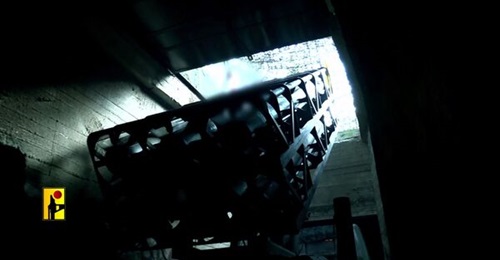A still from a video released by Hizbullah's armed wing on 16 August 2024 shows a multiple rocket launcher being prepared for launch in a tunnel network.