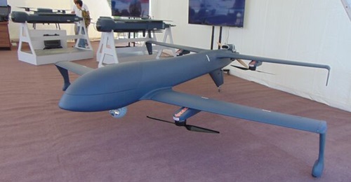 Deftech's DT-101 VTOL UAV on display at ADEX with the F-5000 loitering munitions in the background.