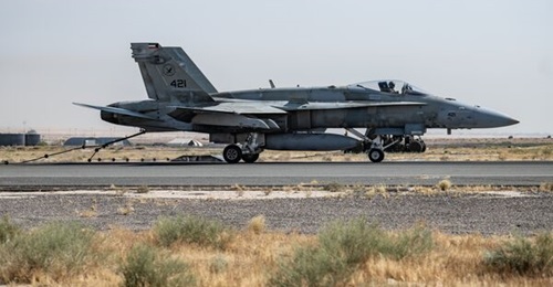 A Kuwait Air Force Boeing F/A-18C of 9 Squadron latches onto a Mobile Aircraft Arresting System (MAAS) following a full-throttle approach at Ali Al Salem Air Base, Kuwait, in July 2023.