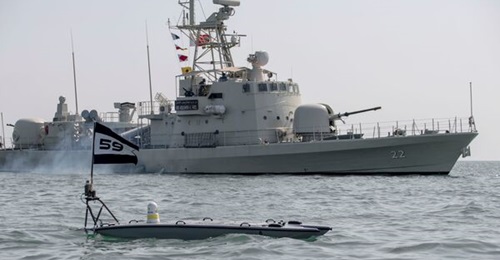 A MANTAS T-12 USV operates alongside the Bahraini fast-attack craft RBNS 
        
         (P 22) during Exercise 'New Horizon' on 26 October.
