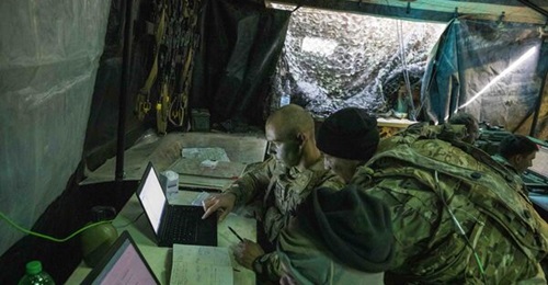A US Army all-source intelligence technician assigned to 2nd Battalion, 34th Armor Regiment, 1st Armored Brigade Combat Team, assists the battalion intelligence officer during Exercise 'Allied Spirit X' in Germany.