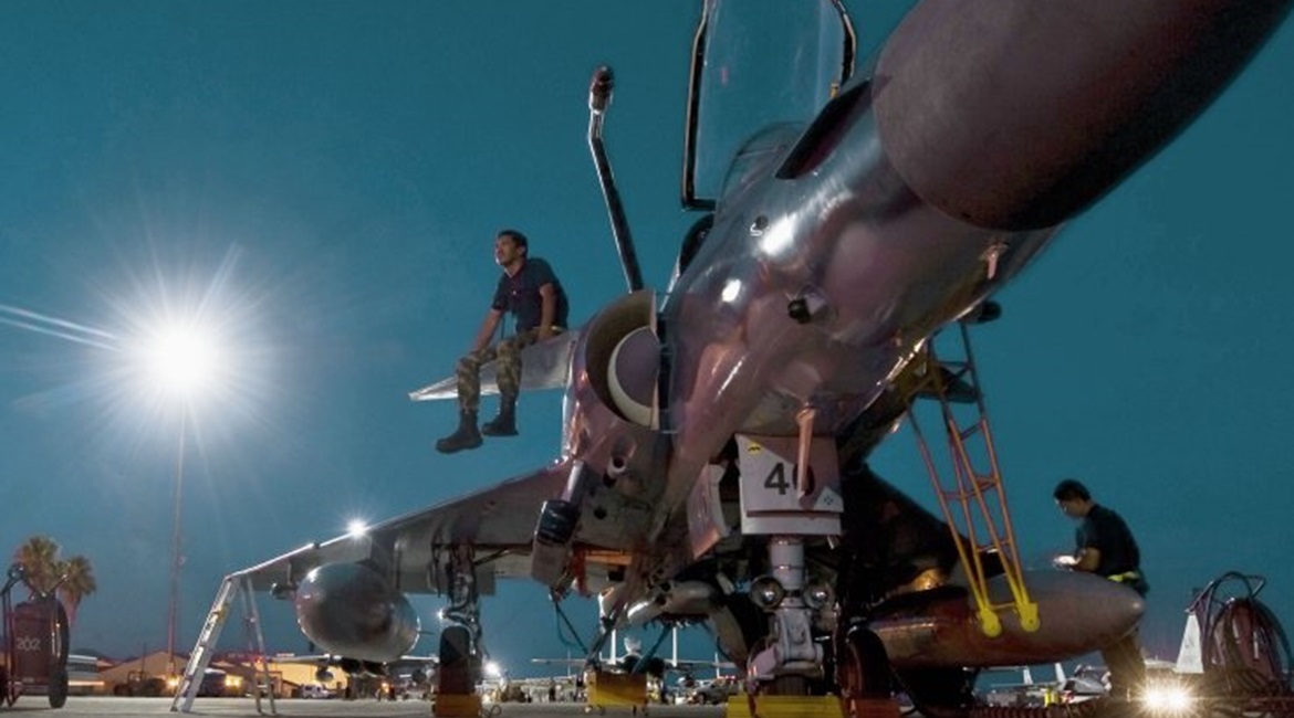 A Colombian air force technician sits on the canard of a Kfir during a 'Red Flag' exercise in 2012. IAI hopes to sell the enhanced Kfir NG to Colombia, and expects to return to service aircraft for Sri Lanka and Ecuador.