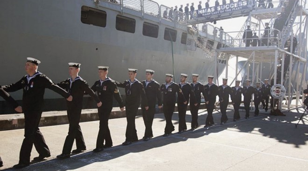 The crew of HMAS 
        
         march off the ship for the last time during the AOR's decommissioning ceremony on 29 June at Fleet Base East, Sydney.