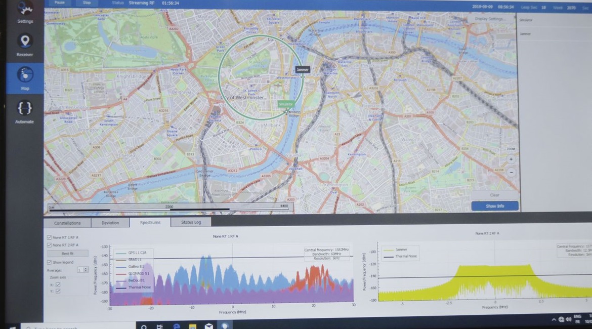 The Orolia GSG-8 GNSS simulation and test platform showing a simulated unmanned aerial vehicle (UAV) with a GNSS receiver flying a circular pattern with a simulated static jammer. The graphs at the bottom of the screen show signals from the different G...