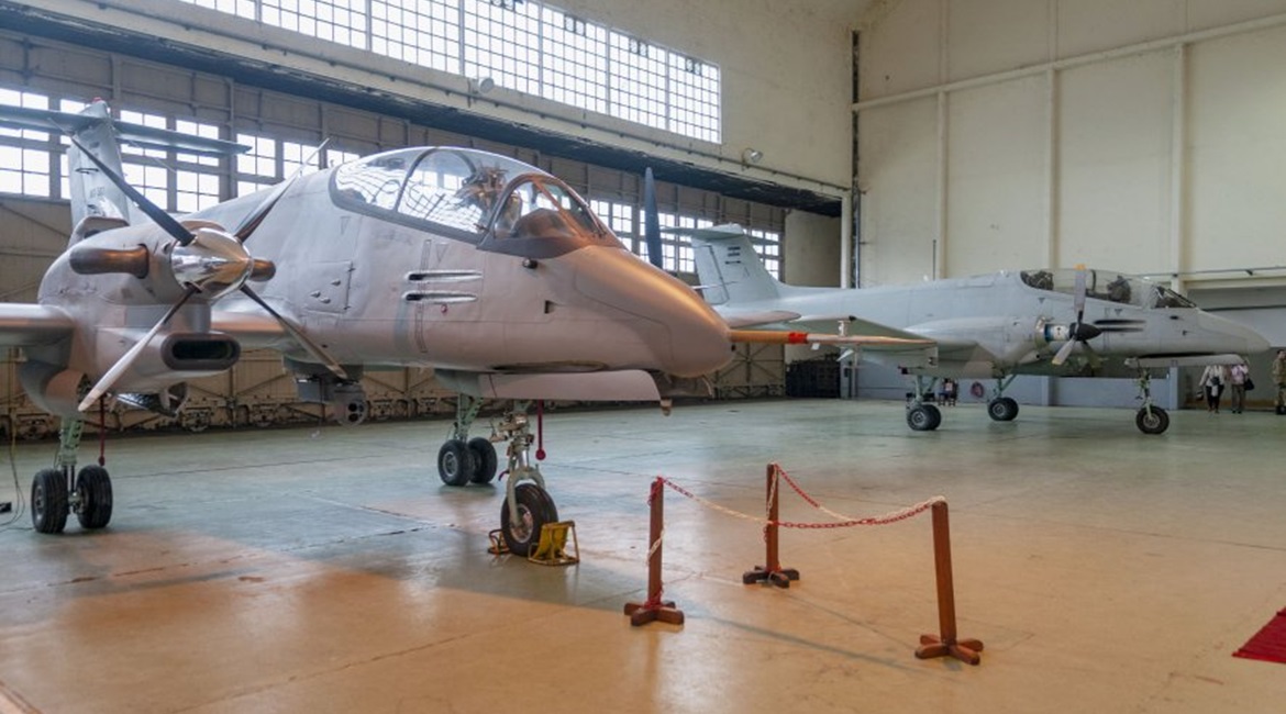 The 'new' Pucara Fenix configuration with its improved engine, four-bladed propellers, and EO/IR sensor turret can been seen in the foreground, while the now-retired light strike version is in the background.