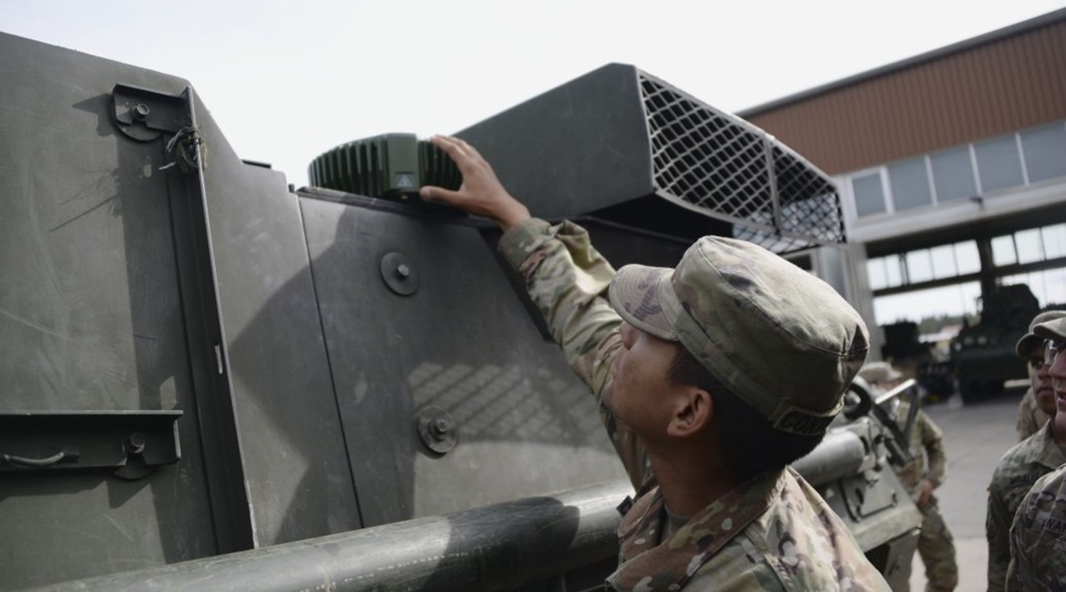 A US soldier checks part of a MAPS anti-jamming GPS device.