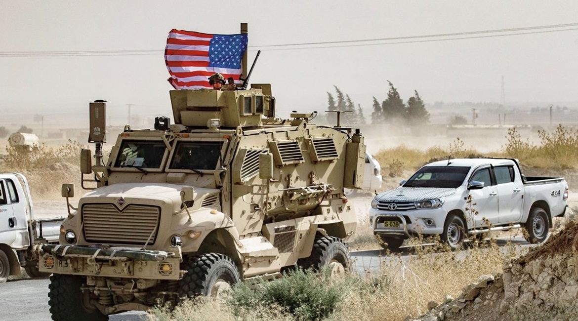 US troops patrol in the Syrian border town of Ras al-Ayn on 6 October, the day their withdrawal was announced by Donald Trump.