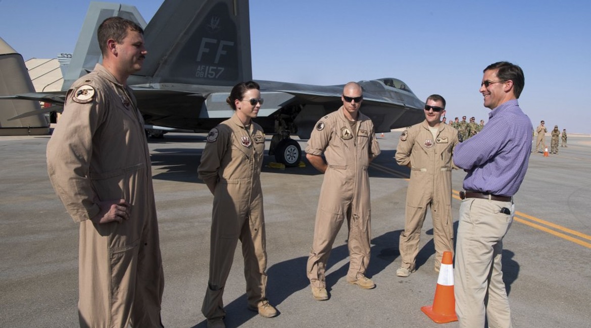 US Secretary of Defense Mark Esper talks to pilots in front of an F-22 Raptor at Prince Sultan Air Base on 22 October.
