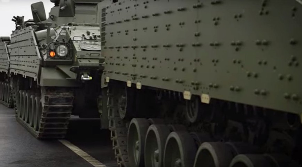 Warrior IFVs, sporting the baseline element of a modular armour package that can be tailored to specific threats, being loaded at the British Army's Ludgershall vehicle depot as part of the UK's 'Tractable' deployment.