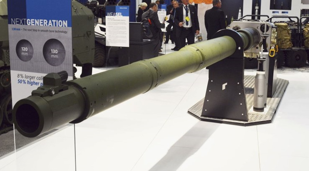 The Rheinmetall NG 130 mm tank gun is shown with two APFSDS rounds to the right. The first is a standard current 120 mm round with the second, to the rear, the much longer 130 mm round.