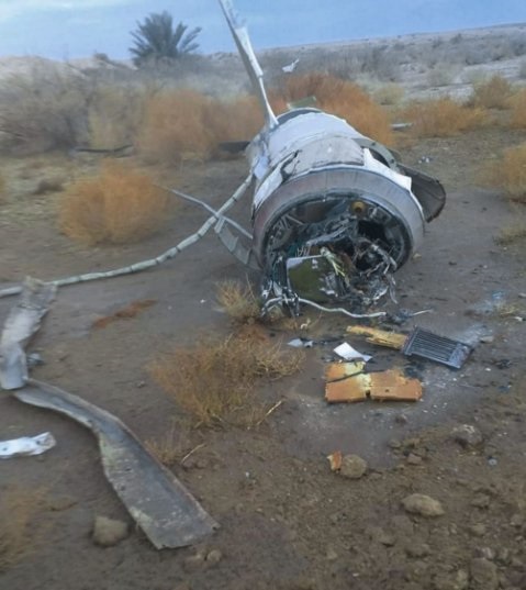 The remnants of a missile are seen near Al-Baghdadi, about 10 km from Iraq's Ain al-Asad Air Base on 8 January. It shows the top of the rocket motor where the guidance section tapers towards the re-entry vehicle, which is not present. The conduits that...