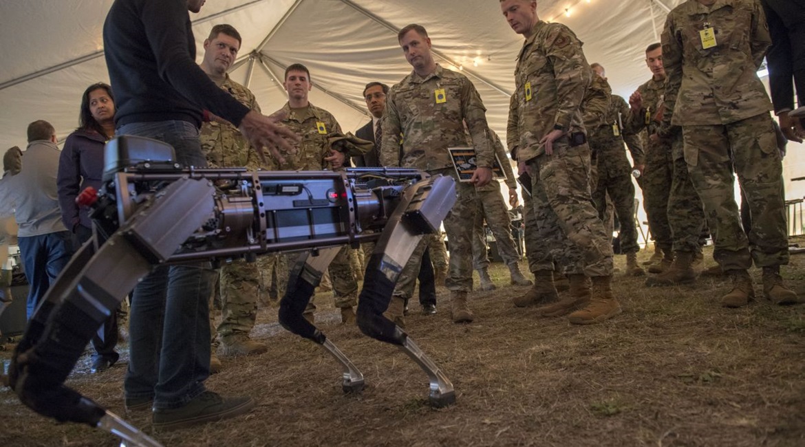 Jiren Parikh (foreground), Ghost Robotics CEO, briefs USAF service members on 18 December 2019 on the capabilities of the 'Robodogs' during a technology showcase for the Advanced Battle Management System (ABMS) demonstration at Eglin Air Force Base in ...