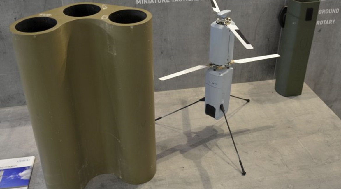A Rafael Spike Firefly munition is pictured in the middle, with a three-munition launcher for vehicles on the left, and a transport canister for infantry on the right.