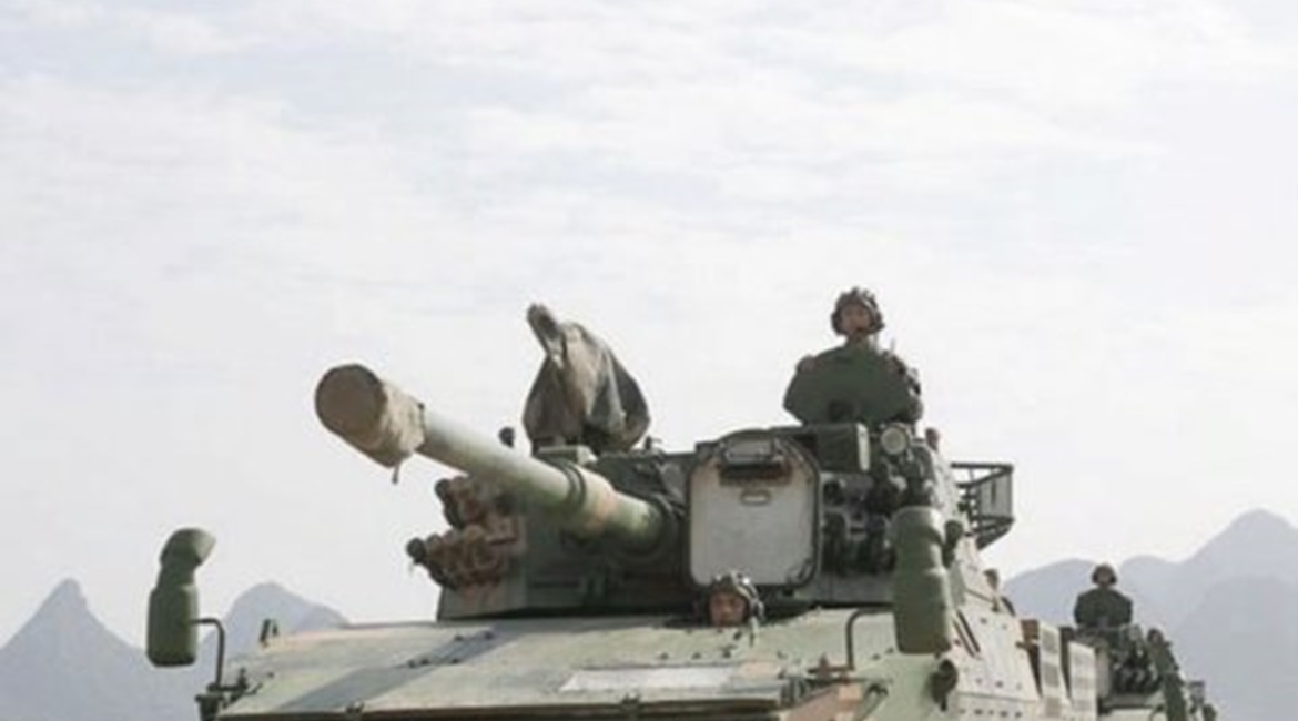 An image showing Harwar's Zhanfu (Tomahawk) H16-V12 UAV hovering over a PLA Ground Force ZBD-09 wheeled self-propelled gun at an undisclosed location: an indication that the UAV is either being trialled by or already in service with the PLA.