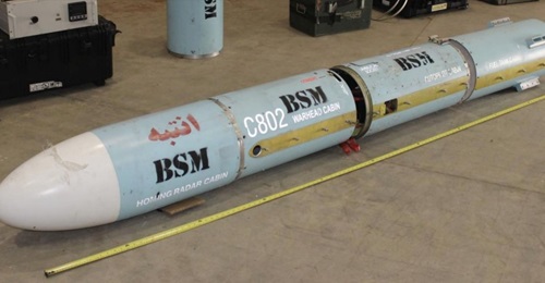 Four sections of the C802 anti-ship missile that was found on the dhow are seen lined up. The motor sections, wings, control surfaces, and conduits are not seen. The Arabic word for caution is written on the seeker section.