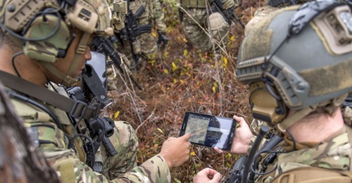Members of the US Air Force's 6th Special Operations Squadron use a tablet to upload co-ordinates during an exercise showcasing the capabilities of the Advanced Battle Management System at Duke Field, Florida, on 17 December 2019.