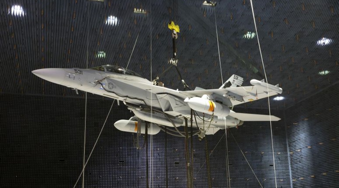 Two Next Generation Jammer Mid-Band (NGJ-MB) pods, attached to an EA-18G Growler, undergo testing in the Air Combat Environmental Test and Evaluation Facility anechoic chamber at Naval Air Station Patuxent River in Maryland.