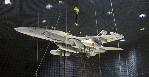 Two Next Generation Jammer Mid-Band (NGJ-MB) pods, attached to an EA-18G Growler, undergo testing in the Air Combat Environmental Test and Evaluation Facility anechoic chamber at Naval Air Station Patuxent River in Maryland.