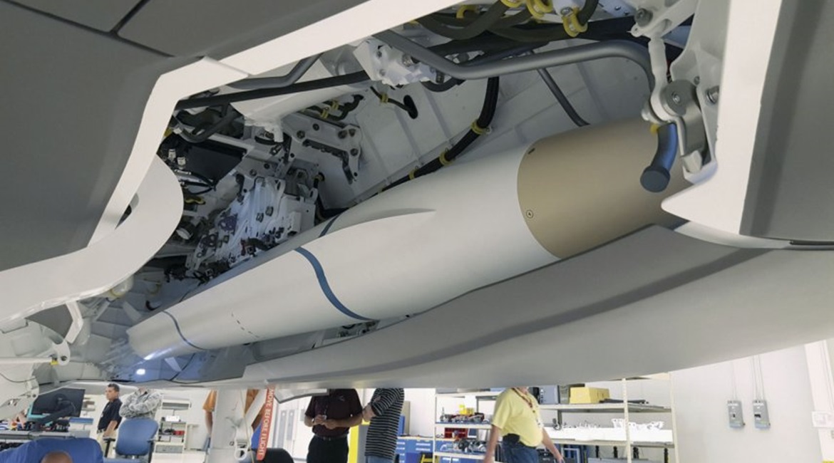 A model of the AARGM-ER missile being used for a fit check in an F-35 weapons bay.