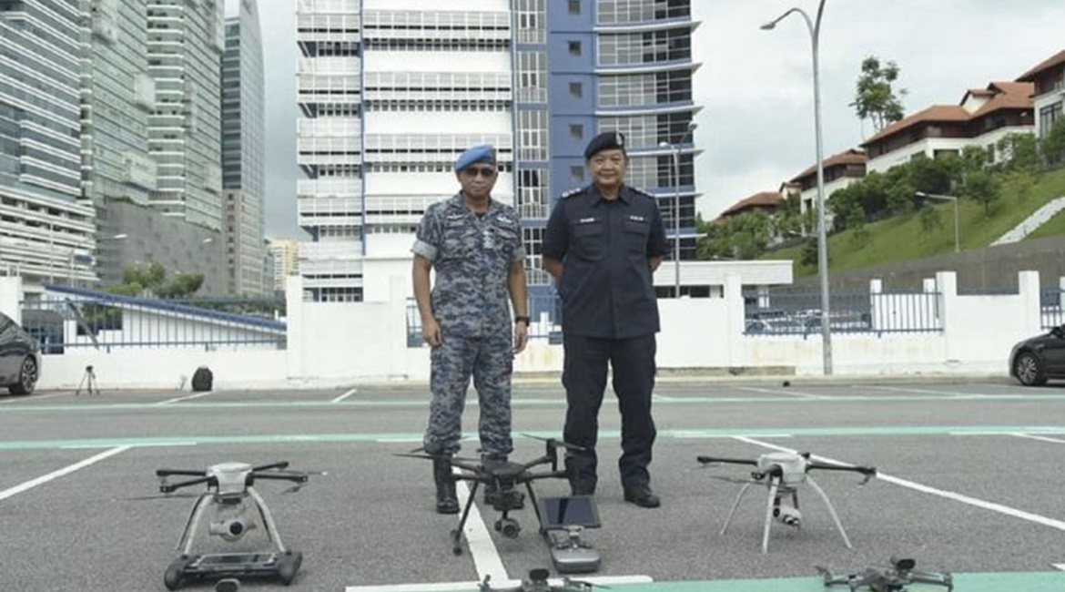 Malaysian Chief of Defence Force General Affendi Buang and Inspector General of Police Hamid Bador with the unmanned systems that have been deployed for enforcing the Movement Control Order in Malaysia.