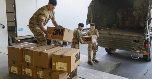 UK military personnel delivering boxes of PPE face masks to St Thomas Hospital in London on 24 March.