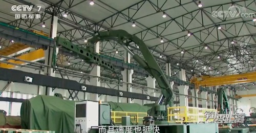 A screen grab from a CCTV 7 video showing what the broadcaster described as a “large, crane-like robot that can be used in lifting and loading missiles onto transporter-erector launchers”. The system is reportedly entering service with the ...