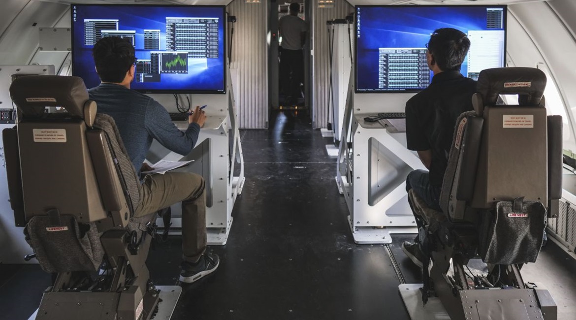 Launch engineers monitor data screens on Cosmic Girl's flight deck