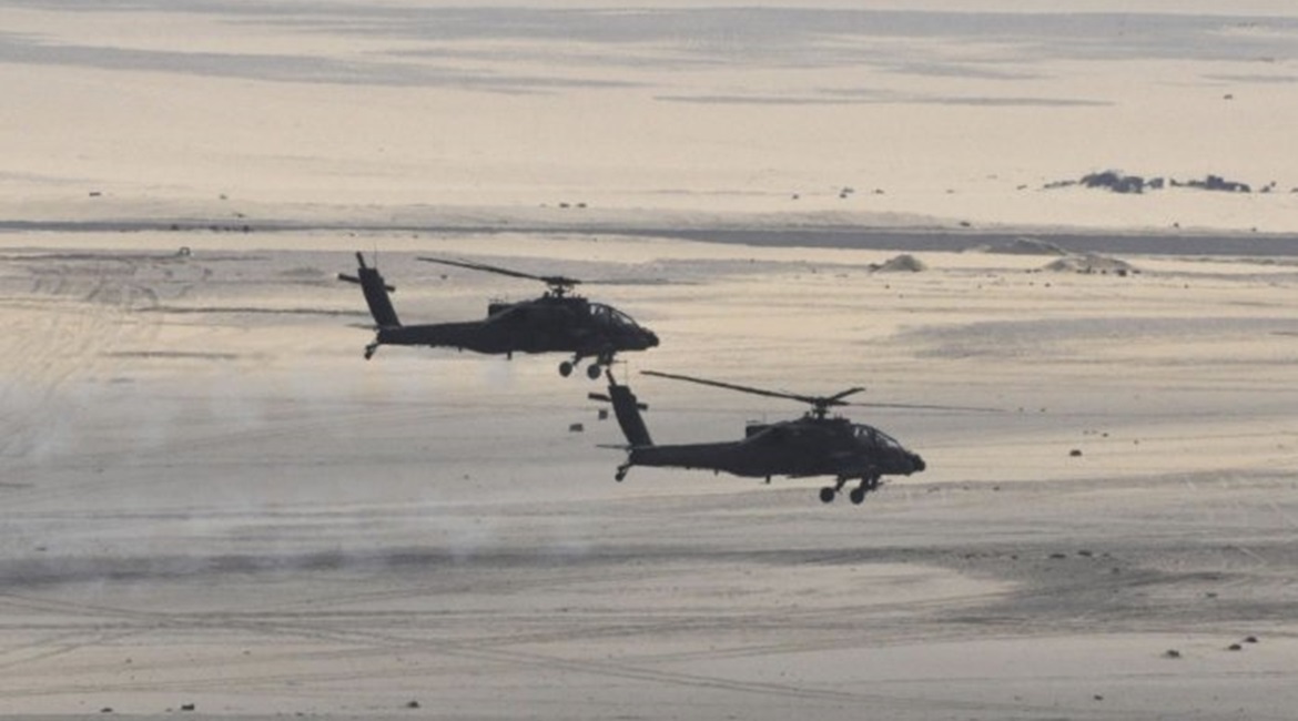Two Egyptian Air Force AH-64D Apache attack helicopters are seen in a photograph released by the Egyptian MoD in February 2018. The country is set to upgrade its fleet of 43 such helicopters to the latest AH-64E standard, according to the DSCA.