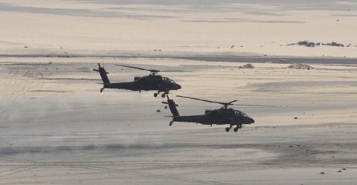 Two Egyptian Air Force AH-64D Apache attack helicopters are seen in a photograph released by the Egyptian MoD in February 2018. The country is set to upgrade its fleet of 43 such helicopters to the latest AH-64E standard, according to the DSCA.