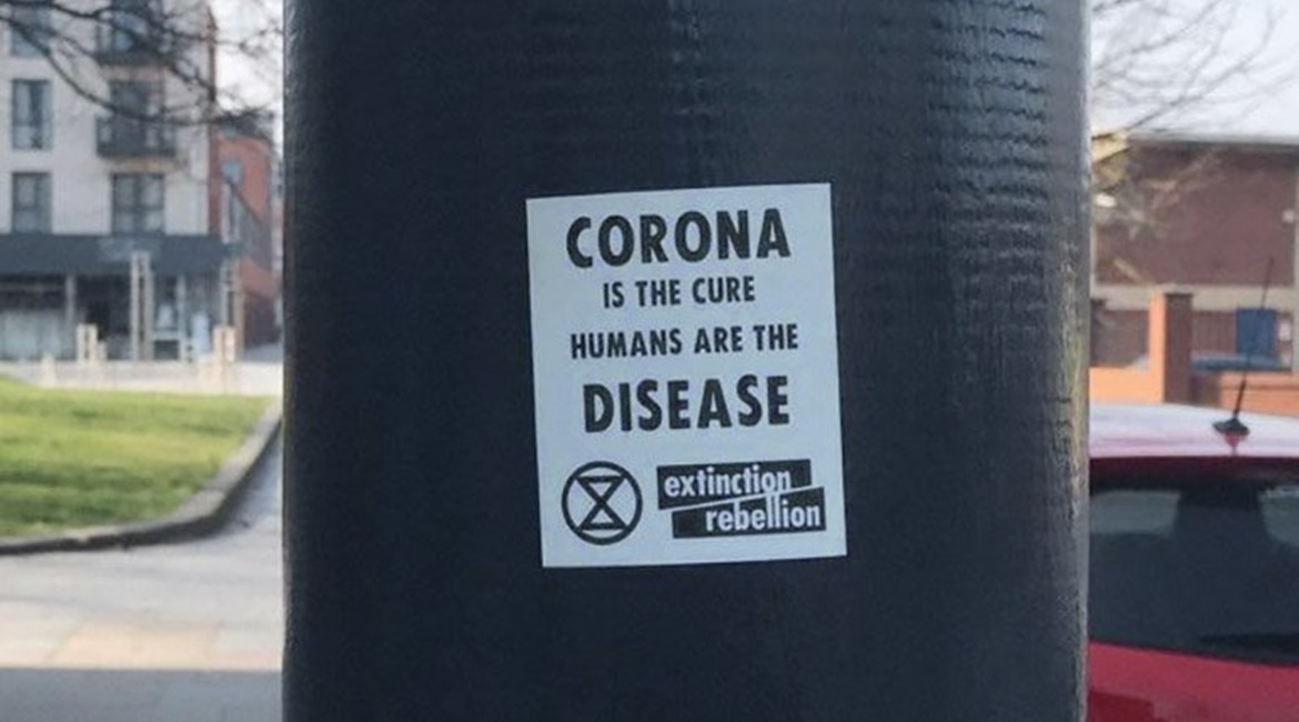 An image of a fake Extinction Rebellion sticker with a message on the Covid-19 pandemic that conveys eco-fascist themes, that was posted by a now-suspended Twitter account. The stickers were left on lampposts in Bedford and Brighton.