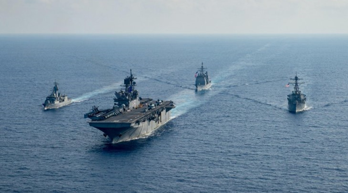 RAN guided-missile frigate HMAS 
        
         (FFH 154), left, sails with USN amphibious assault ship USS 
        
         (LHA 6), guided-missile cruiser USS 
        
         (CG 52), and guided-missile destroyer USS 
        
      ...