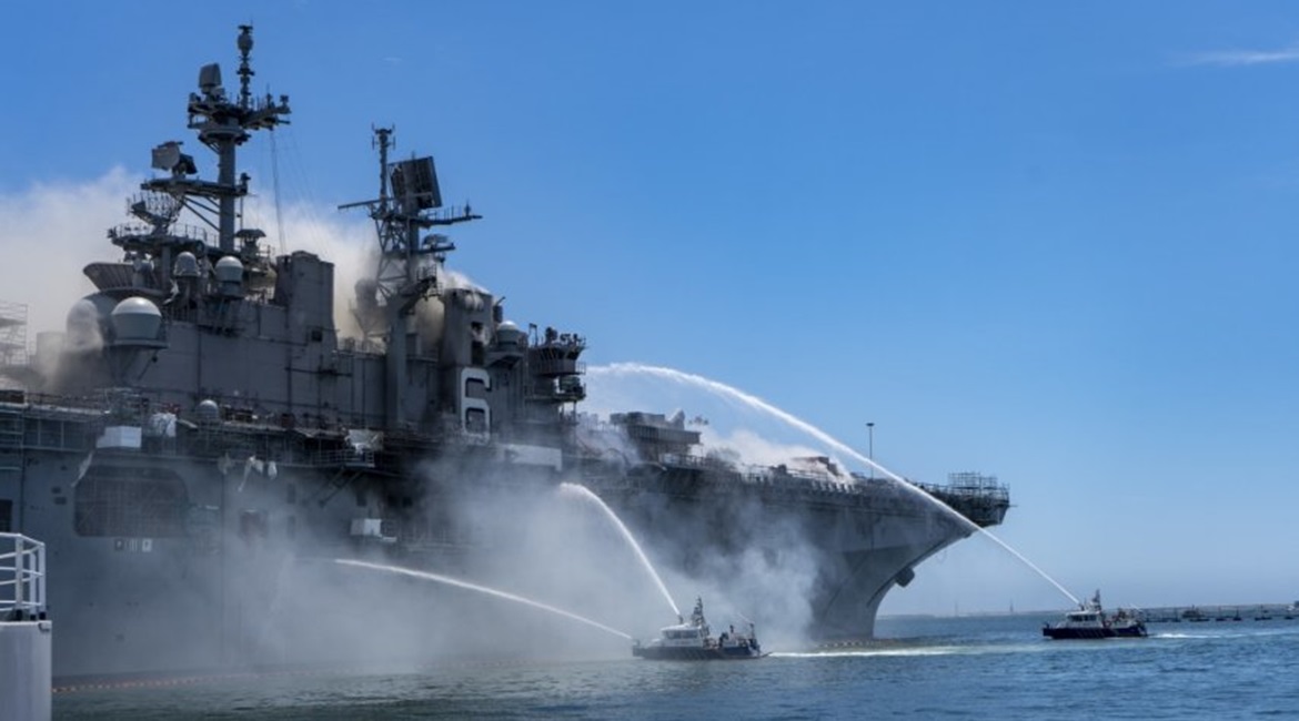 Port of San Diego Harbor Police Department boats combat a fire on board USS 
        
         (LHD 6) at Naval Base San Diego on 12 July.