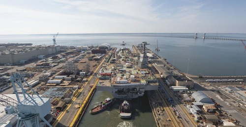 Following a fire on 20 July, hotwork was halted on aircraft carrier John F. Kennedy, which was launched in December from a dry dock in Newport News Shipbuilding.