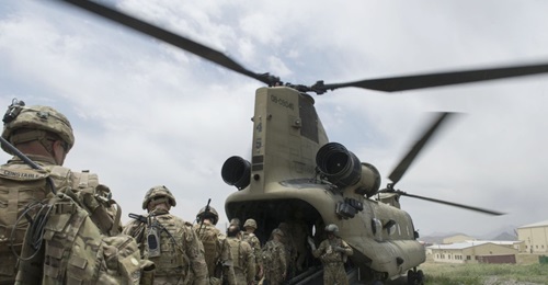 US soldiers enter a US Army CH-47 Chinook helicopter at an Afghan National Army combat outpost in Afghanistan on 23 June 2015. US President Donald Trump has announced plans to further cut the number of US troops in Afghanistan to between 4,000 and 5,00...