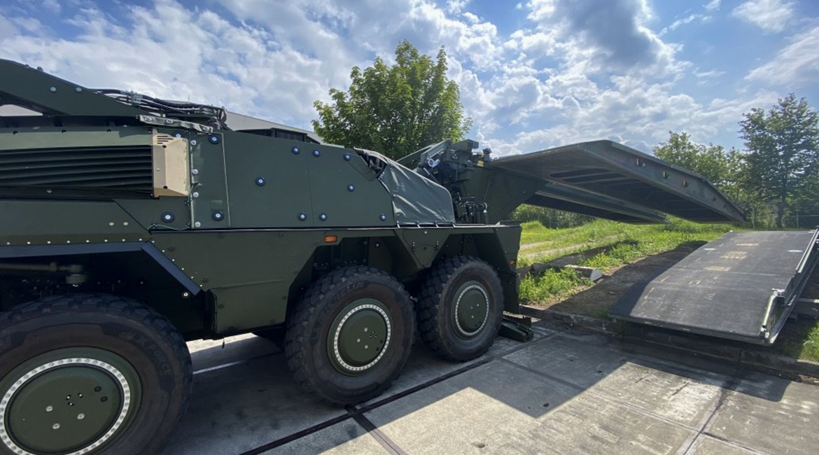 A Boxer fitted with rear mission module launching a Leguan 14 m bridge to Military Load Class 80 over the rear of the platform.