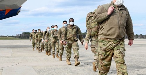 US Army Reserve Soldiers assigned to Urban Augmentation Medical Task Forces arrive at Hanscom Air Force Base, Massachusetts on 17 April, 2020. Officials with the Pentagon's National Geospatial Intelligence Agency are developing a predictive analysis pr...