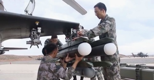 A screengrab from CCTV 7 footage released online on 6 August showing two units of a new ATGM being loaded onto one of the launchers of a PLAGF Z-10 attack helicopter. The launcher is also carrying what appears to be a pod.