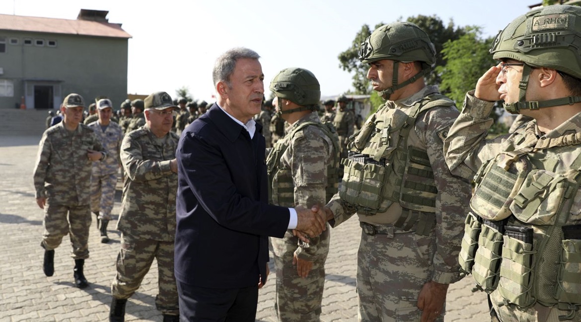 Turkish Minister of Defence Hulusi Akar greets soldiers working on the original 'Claw' operation in Hakkari, Turkey, on 4 June 2019. The operations expanded significantly a year later.