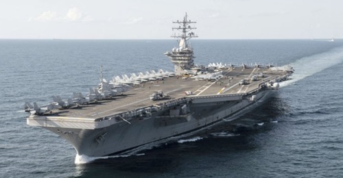 Aircraft carrier USS 
        
         (CVN-69) spent 18 months in a maintenance availability ending in 2019. The work was initially scheduled to take only six months.