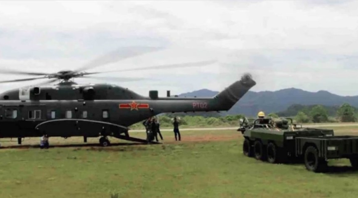 A screengrab from CCTV footage showing the wide-body variant of the CAIG Z-8G medium-lift helicopter shortly before undertaking load-carrying trials with the all-terrain vehicle seen next to it.
