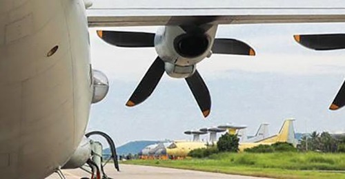 A PLANAF KQ-200 ASW-capable aircraft (foreground) preparing to take part in a flight training exercise on 19 August. A KJ-500 AEW&C aircraft painted in yellow primer and fitted with an IFR probe can be seen in the background parked alongside other airc...