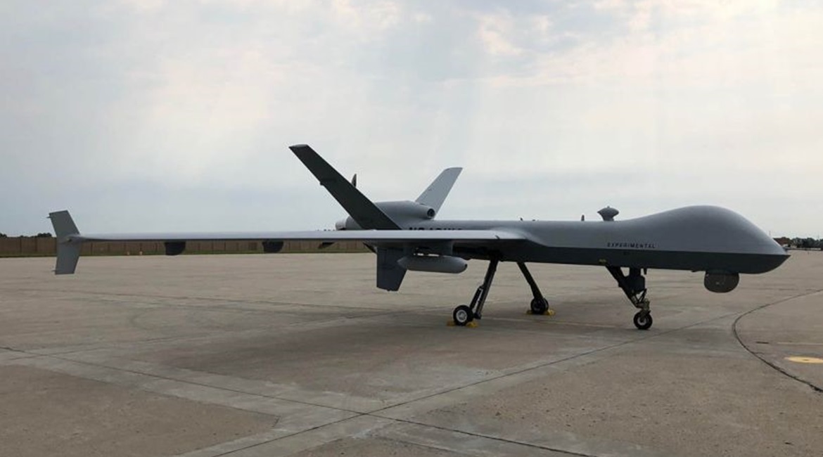 A US Air Force MQ-9 Reaper UAS, equipped with Air Force Research Laboratory's Agile Condor high-power computing pod, sits on the runway of General Atomics' Flight Test and Training Center in Grand Forks, North Dakota. The Pentagon's Joint Artificial In...