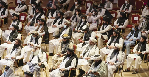 Members of the Taliban delegation attend the opening session of the peace talks between the Afghan government and the Taliban in the Qatari capital Doha on 12 September 2020. Both the likelihood and timing of a complete US troop withdrawal from Afghani...