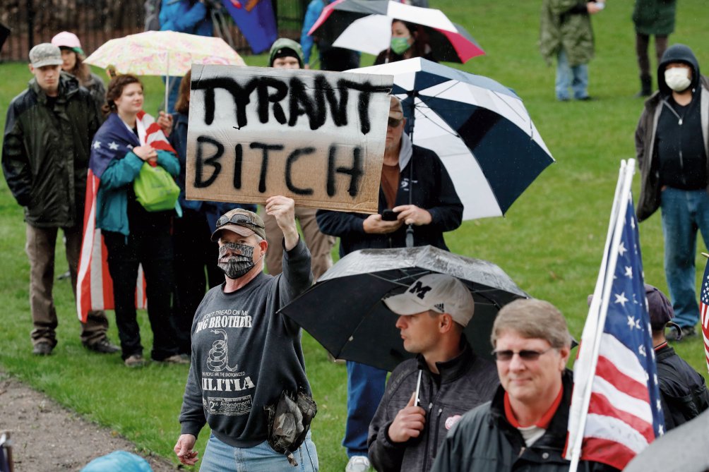 A group of individuals attends an anti-shutdown rally at the Capitol in Lansing in the state of Michigan on 14 May 2020 to protest against Governor Gretchen Whitmerâs Covid-19-related restrictions. (Getty Images)