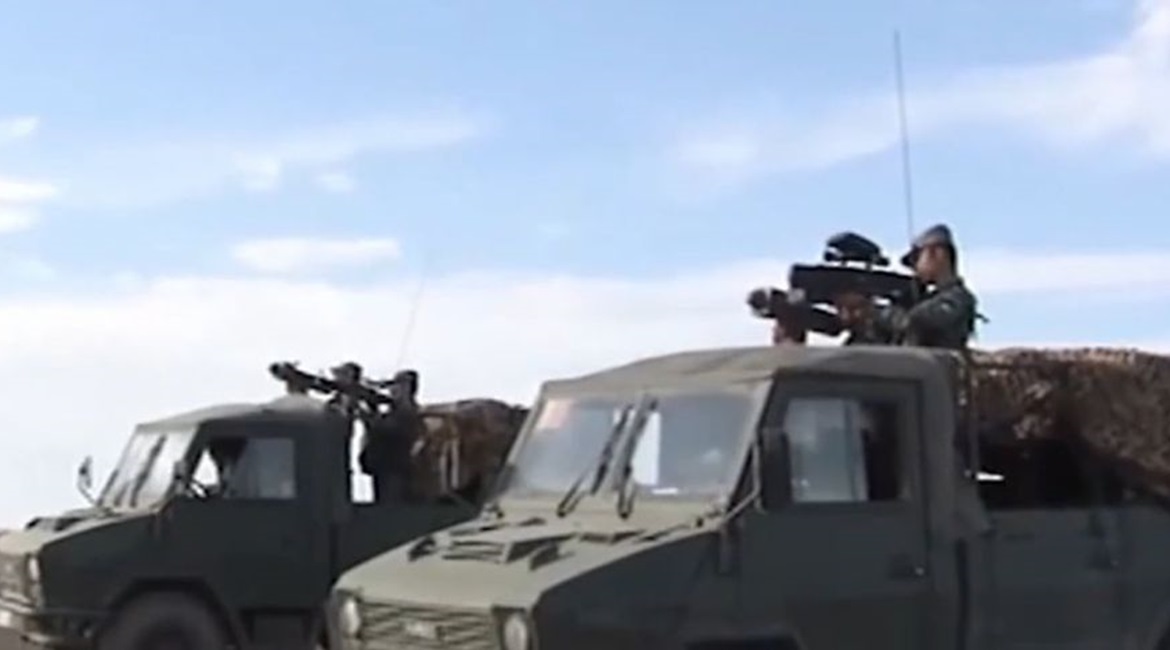 Two of the vehicles used in the exercise. One of the vehicles (foreground) is carrying soldiers equipped with a MANPADS and a handheld jammer while the other is carrying soldiers equipped with a similar MANPADS and what appears to be a net gun.