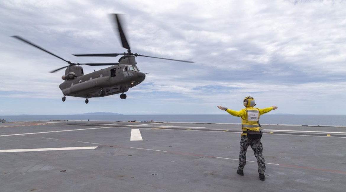 An RSAF CH-47 helicopter landing aboard HMAS 
        
         off the coast of Townsville, Queensland. Canberra announced on 25 October that RSAF CH-47 crews have qualified to operate from the RAN's two Canberra-class LHDs.