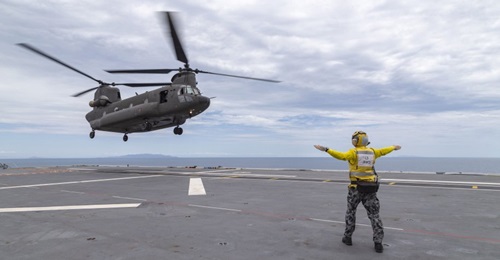 An RSAF CH-47 helicopter landing aboard HMAS 
        
         off the coast of Townsville, Queensland. Canberra announced on 25 October that RSAF CH-47 crews have qualified to operate from the RAN's two Canberra-class LHDs.