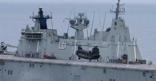 A Republic of Singapore Air Force CH-47 helicopter landing on HMAS 
        
         as part of Exercise 'Sea Wader 2020'.