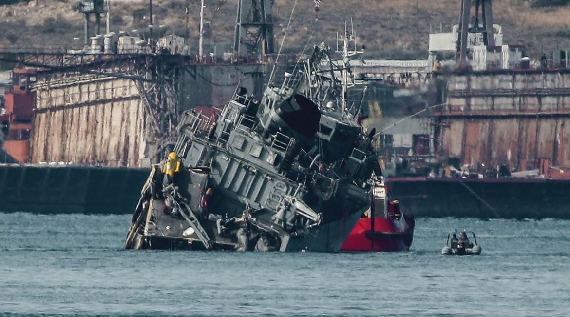 The Greek Navy's minesweeper HS 
        
         being towed back to the naval base after colliding with the Portuguese-flagged cargo ship 
        
         outside the Port of Piraeus in Athens on 27 October.