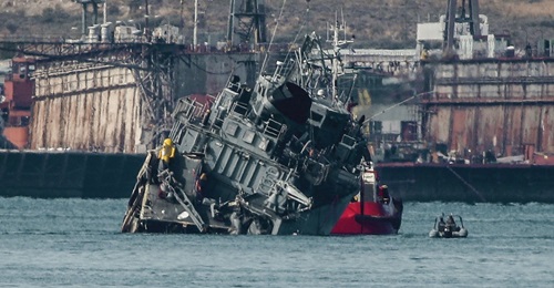 The Greek Navy's minesweeper HS 
        
         being towed back to the naval base after colliding with the Portuguese-flagged cargo ship 
        
         outside the Port of Piraeus in Athens on 27 October.